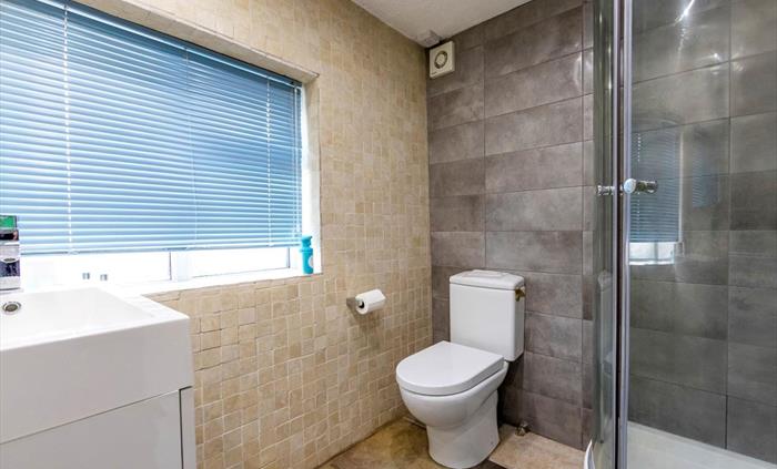 Foxes Reach Wye Valley fully tiled downstairs shower room. Upstairs there is also a smart bathroom with bathtub and shower over,, WC and washbasin, sh